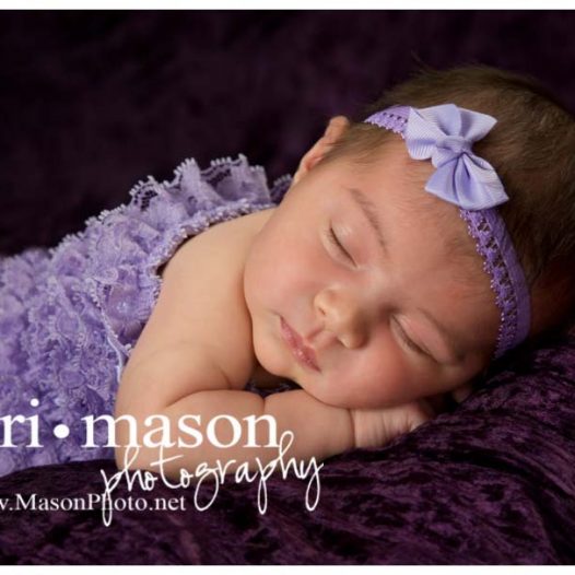 pretty newborn girl in purple